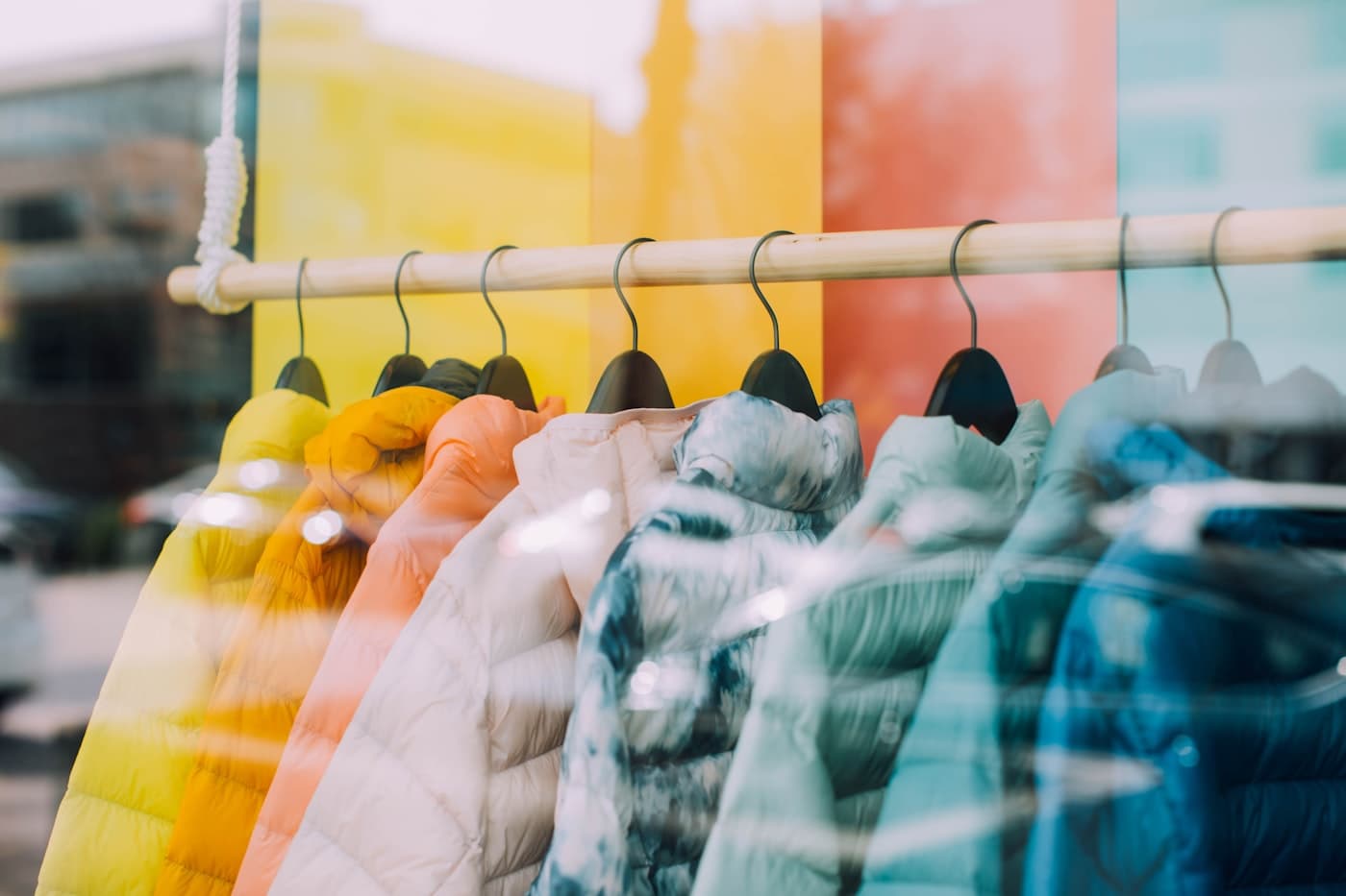 A rack of colourful jackets in a shop window